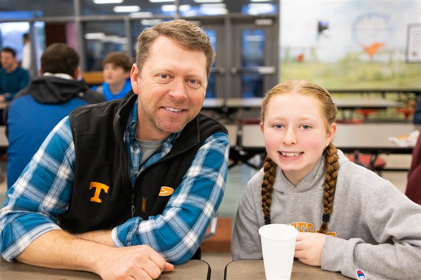 Students and their families enjoy donuts